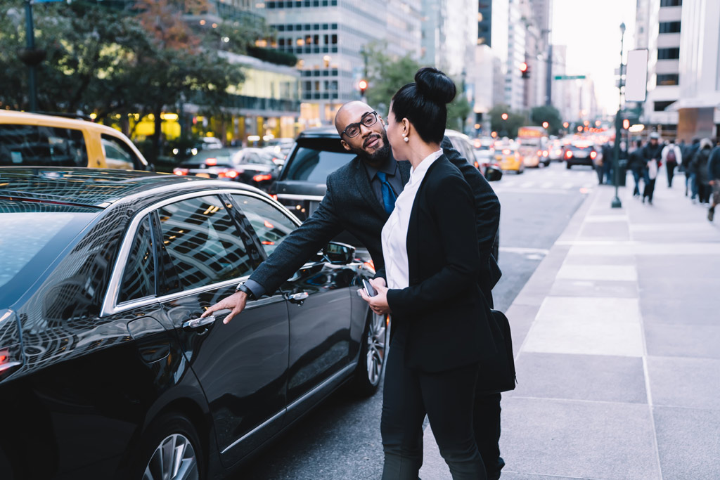 limo driver opens car door for passenger